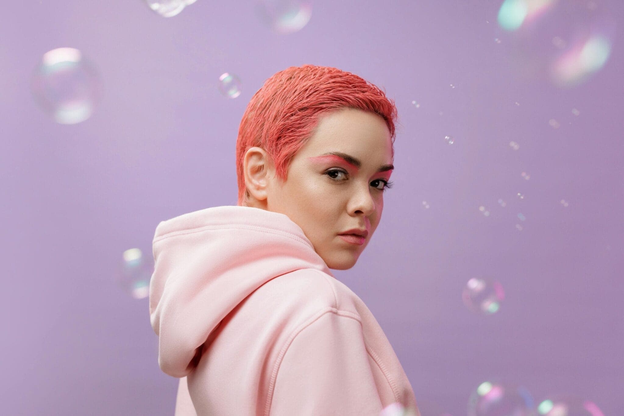 Portrait of a person in a pink hoodie